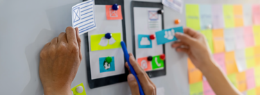 prototyping a web page on a white board with cut outs